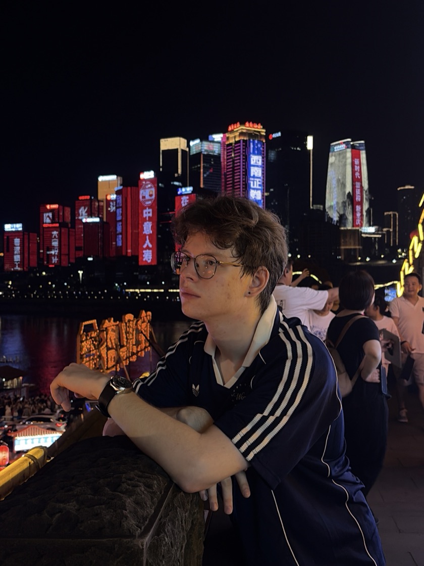 Ivan Shabanov on a waterfront against a night city skyline
